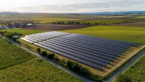 black solar panels on green grass field during daytime